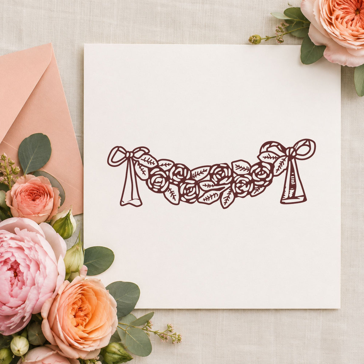 Rose Swag with Bows Rubber Stamp impression in brown ink on white paper in a styled craft setting.