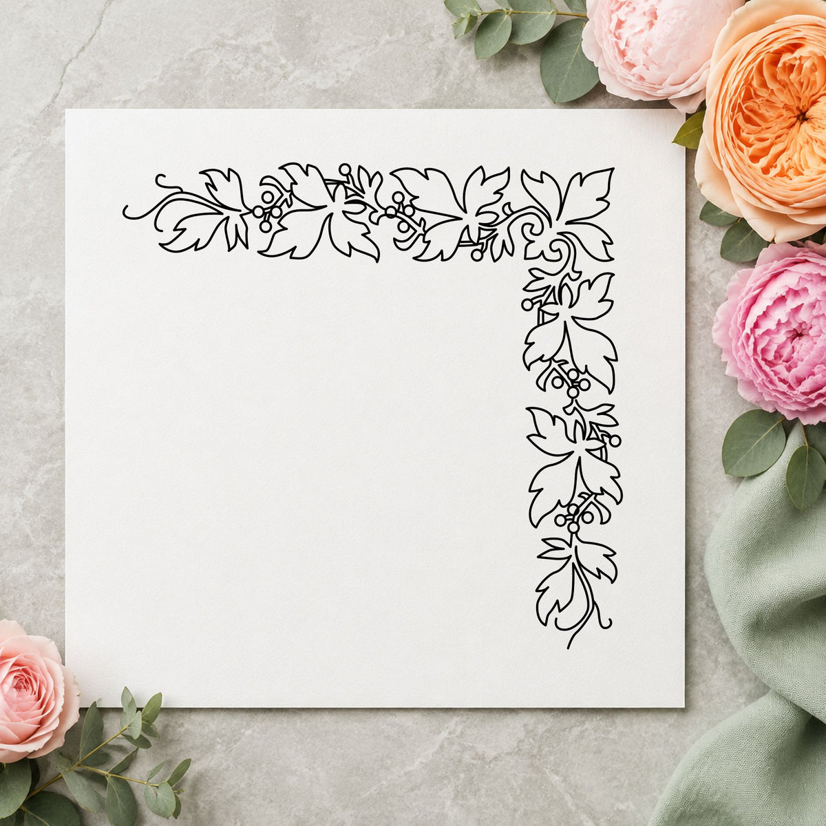 Open Leaf Corner Border Rubber Stamp impression in black ink on white paper in a styled craft setting.