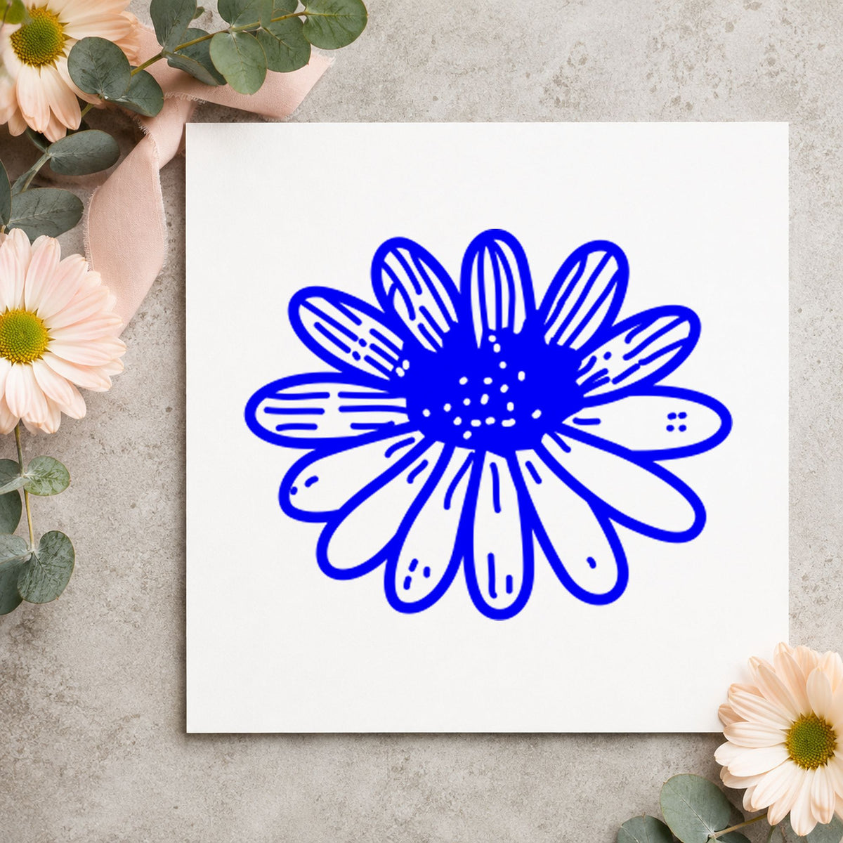 Daisy Flower Rubber Stamp Small impression in blue ink on white paper in a styled craft setting.