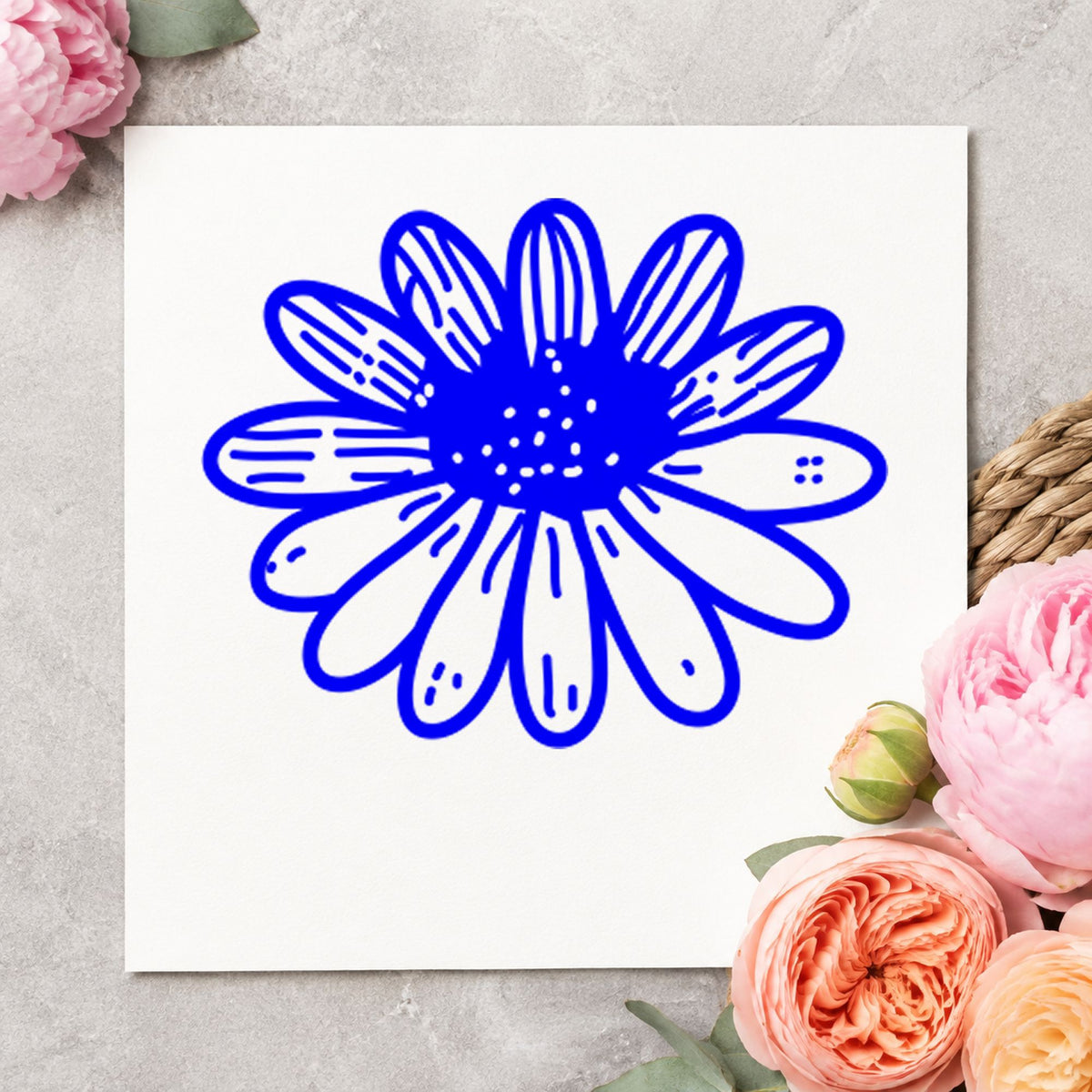 Blue spring scrapbooking stamp impression featuring the daisy flower small design on white paper.