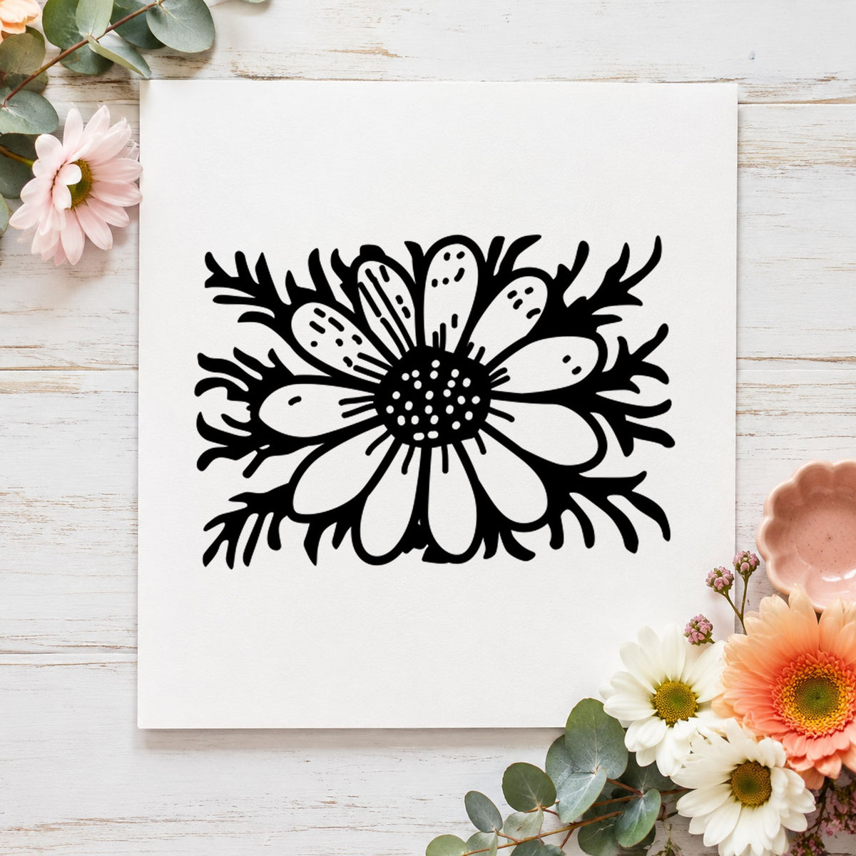 Black impression from a daisy flower stamp, featuring the daisy with stem small design on white paper.