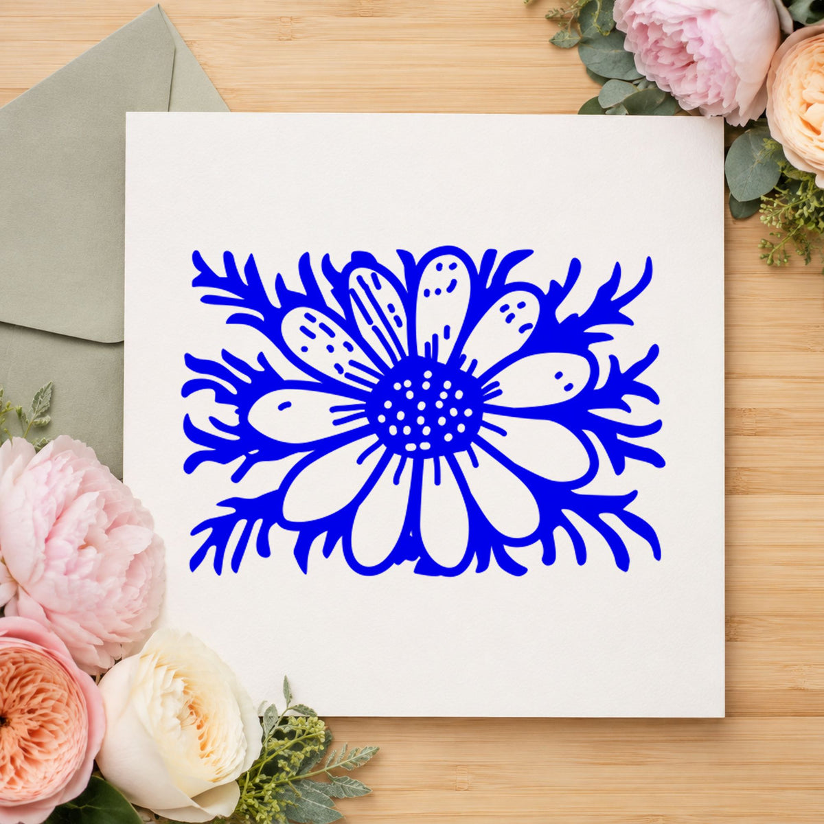Blue botanical craft stamp impression featuring the daisy with stem small design on white paper.