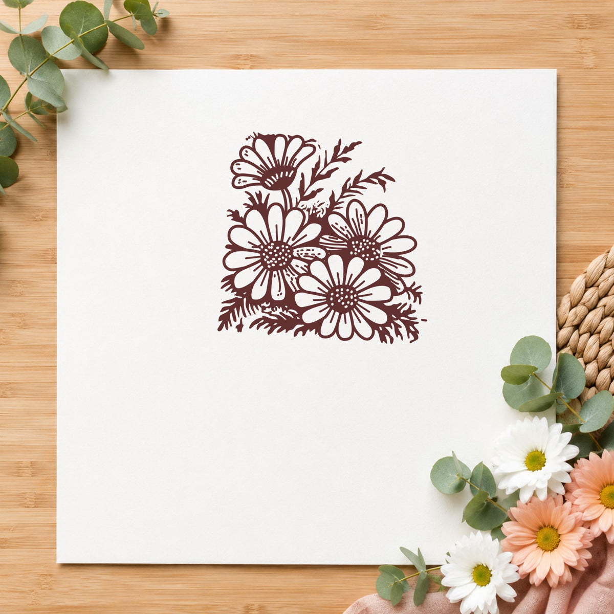 Four Daisy Blooms Rubber Stamp impression in brown ink on white paper in a styled craft setting.