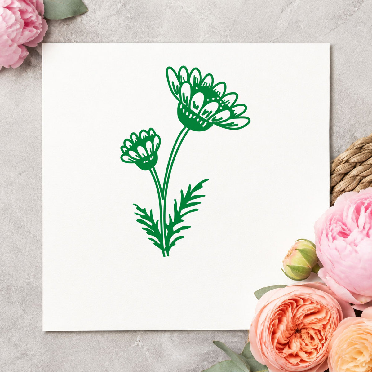 Two Daisies on a Stem Rubber Stamp impression in green ink on white paper in a styled craft setting.