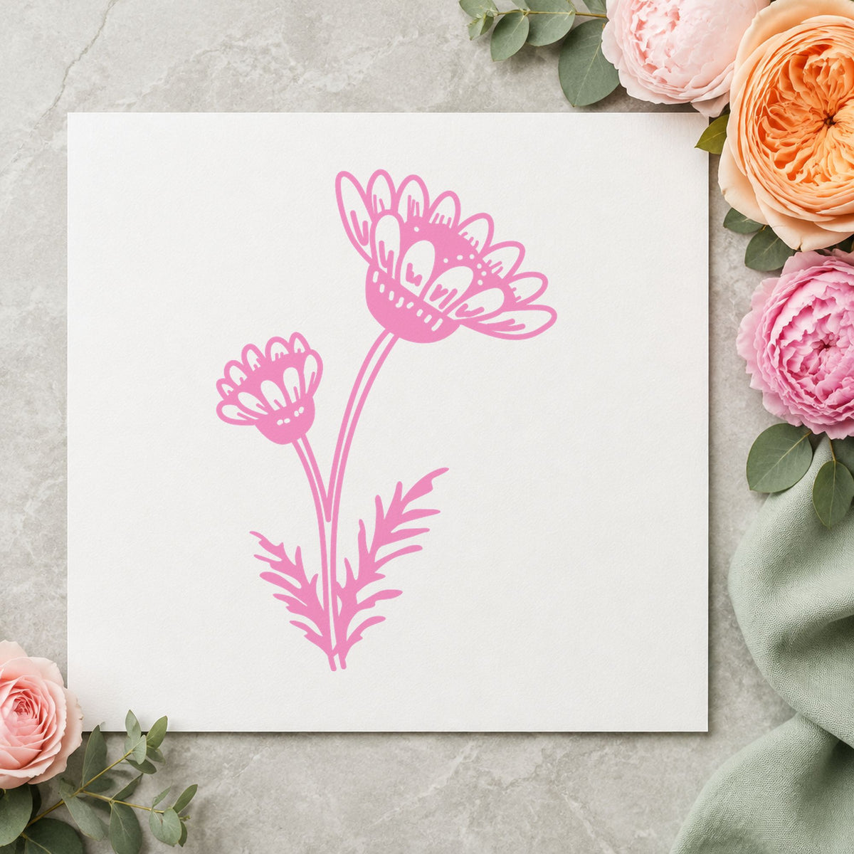 Two Daisies on a Stem Rubber Stamp impression in pink ink on white paper in a styled craft setting.