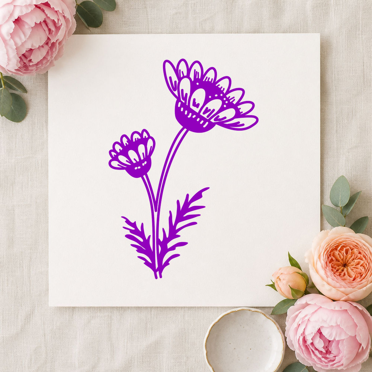 Two Daisies on a Stem Rubber Stamp impression in purple ink on white paper in a styled craft setting.