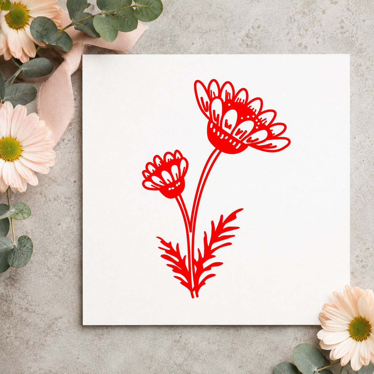 Two Daisies on a Stem Rubber Stamp impression in red ink on white paper in a styled craft setting.