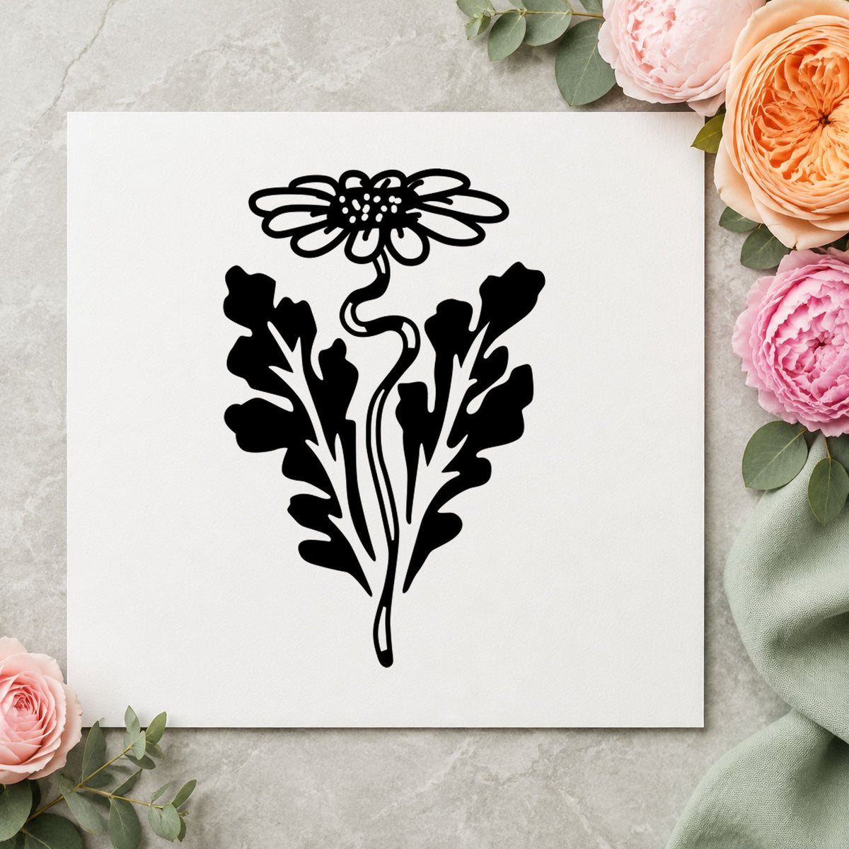 Black impression from a botanical flower stamp, featuring the daisy with leaf design on white paper.