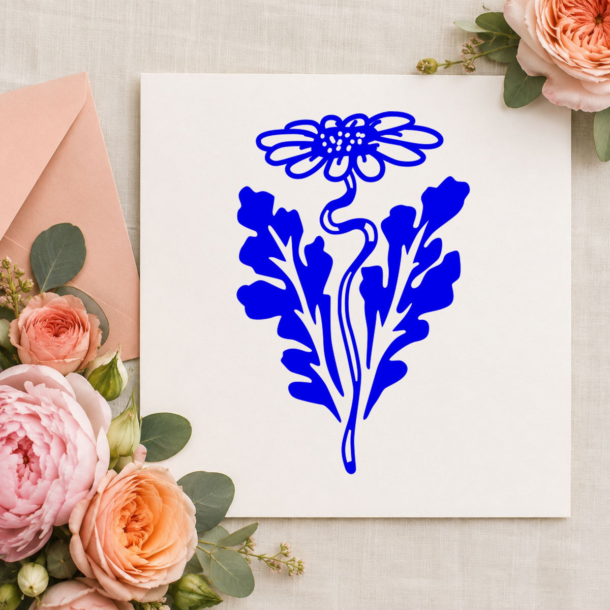 Blue daisy card making stamp impression featuring the daisy with leaf design on white paper.