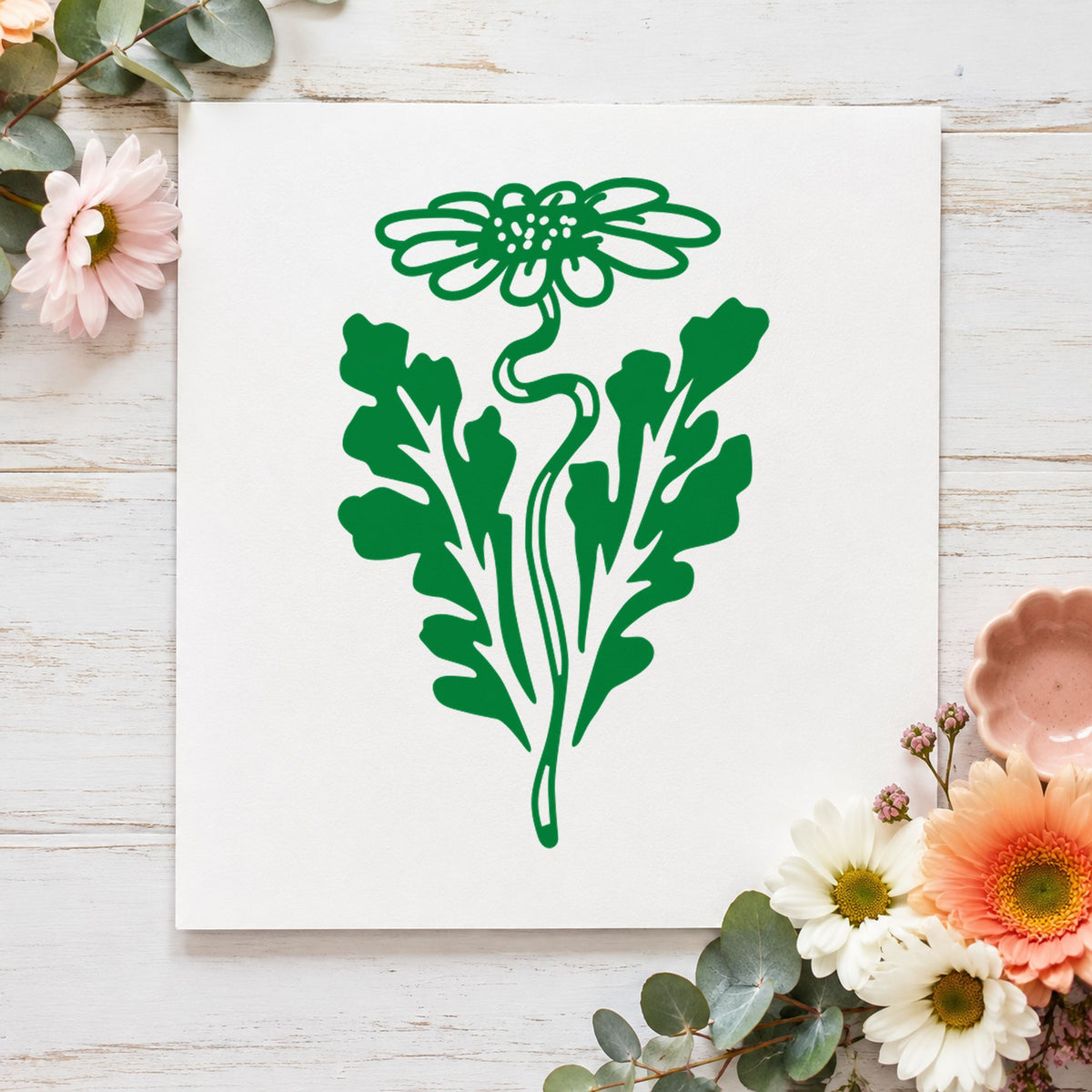 Daisy with Leaf Rubber Stamp impression in green ink on white paper in a styled craft setting.