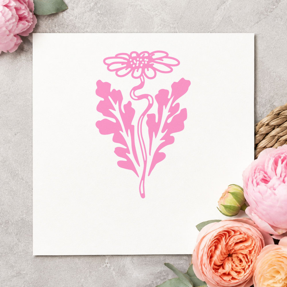 Daisy with Leaf Rubber Stamp impression in pink ink on white paper in a styled craft setting.