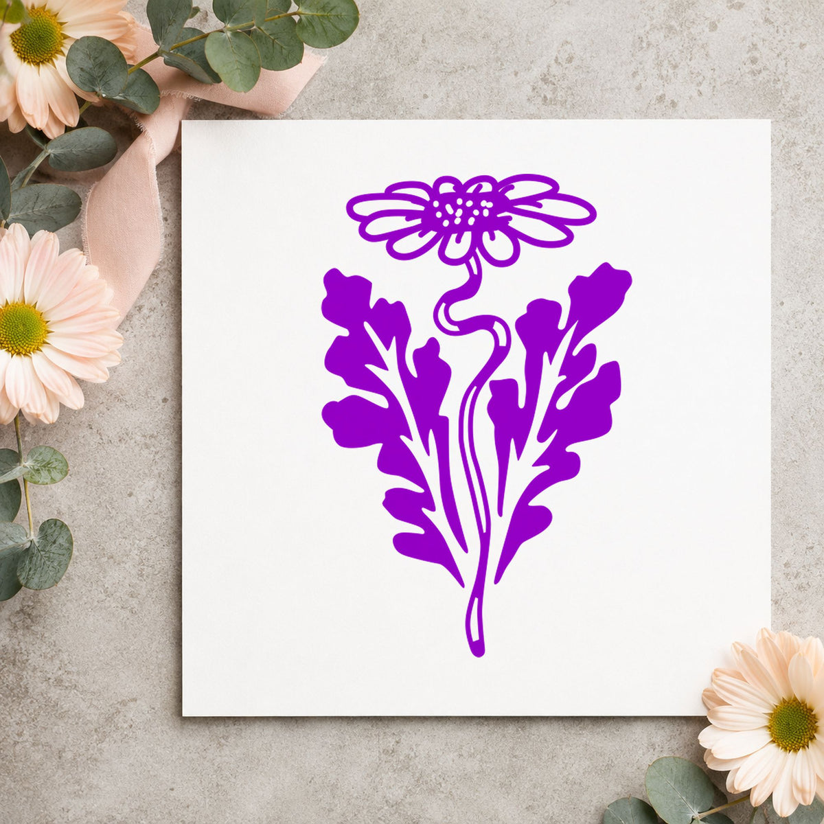 Daisy with Leaf Rubber Stamp impression in purple ink on white paper in a styled craft setting.