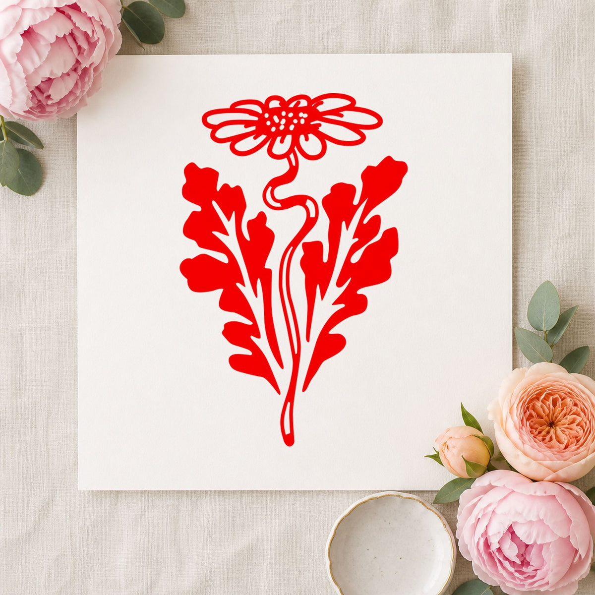 Daisy with Leaf Rubber Stamp impression in red ink on white paper in a styled craft setting.