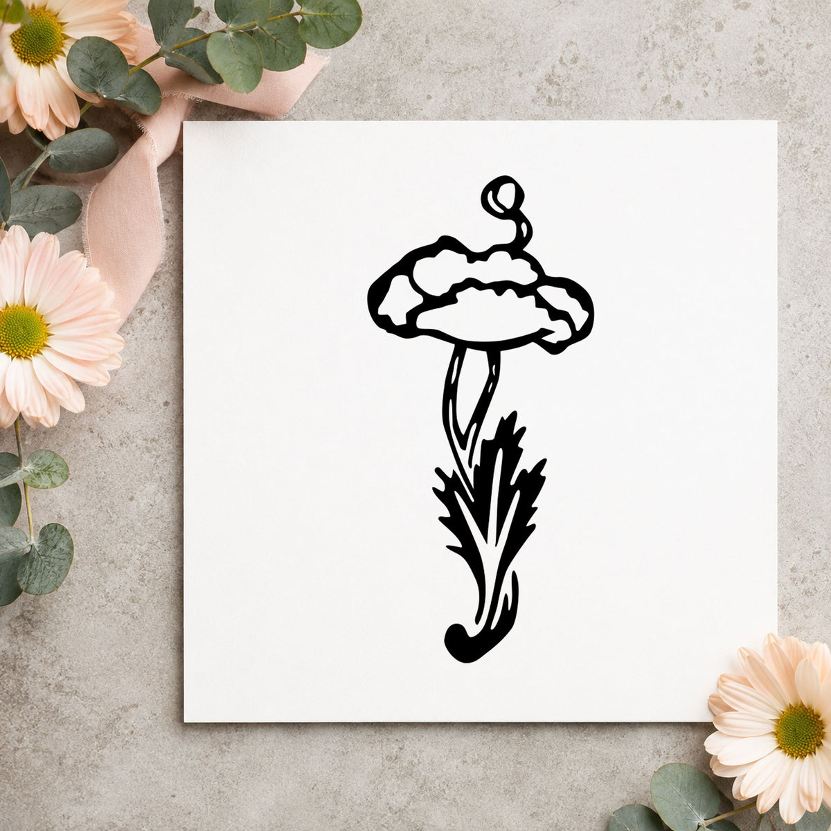 Black impression from a flower stem stamp, featuring the single flower with stem design on white paper.