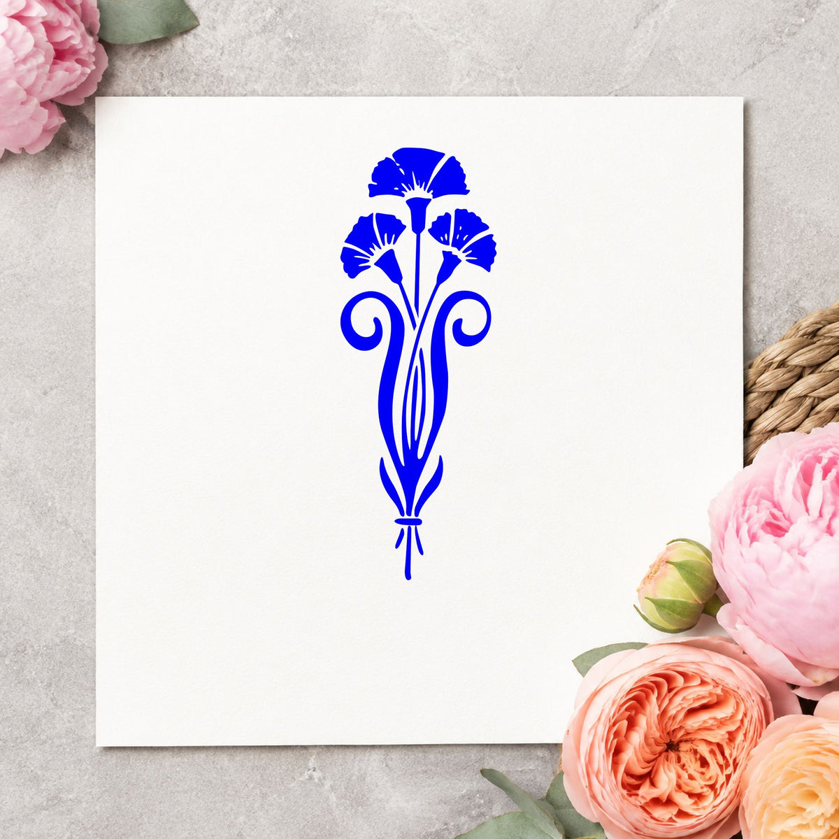 Three Flowers in a Vase Rubber Stamp impression in blue ink on white paper in a styled craft setting.