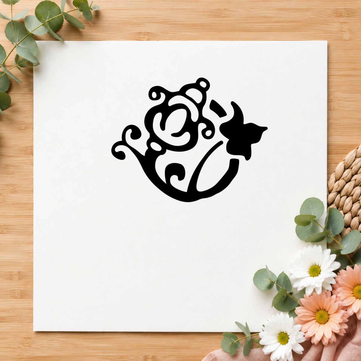 Black impression from a garden rubber stamp, featuring the flower and watering can design on white paper.