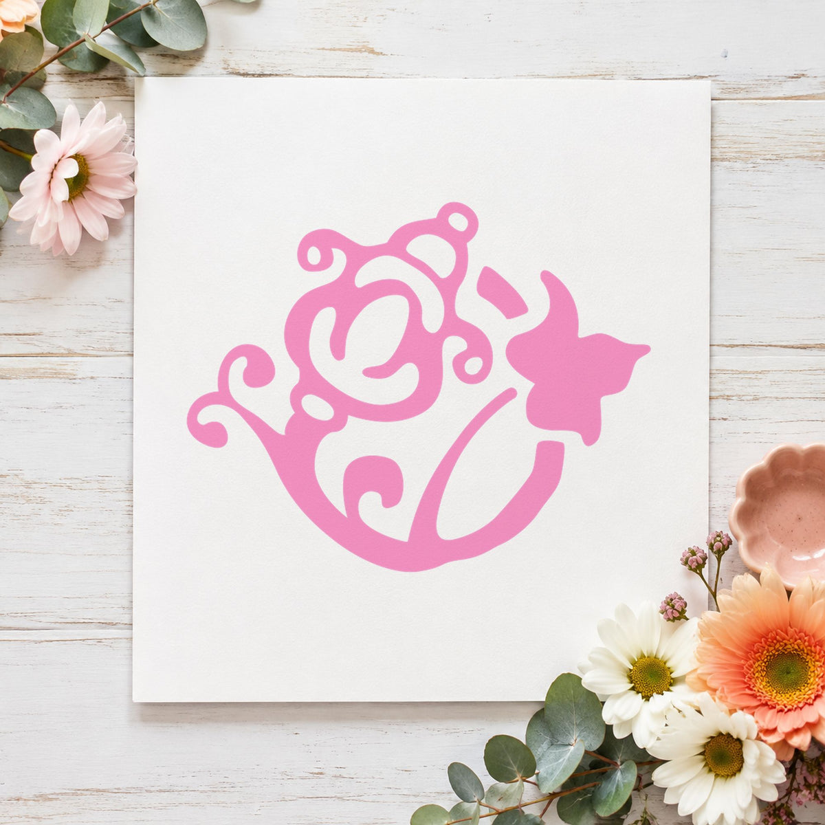 Flower and Watering Can Rubber Stamp impression in pink ink on white paper in a styled craft setting.