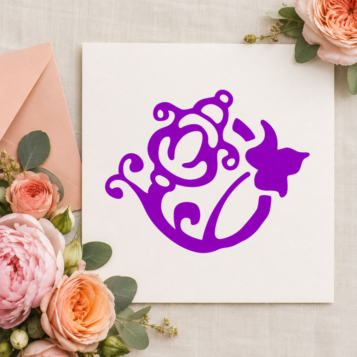 Flower and Watering Can Rubber Stamp impression in purple ink on white paper in a styled craft setting.