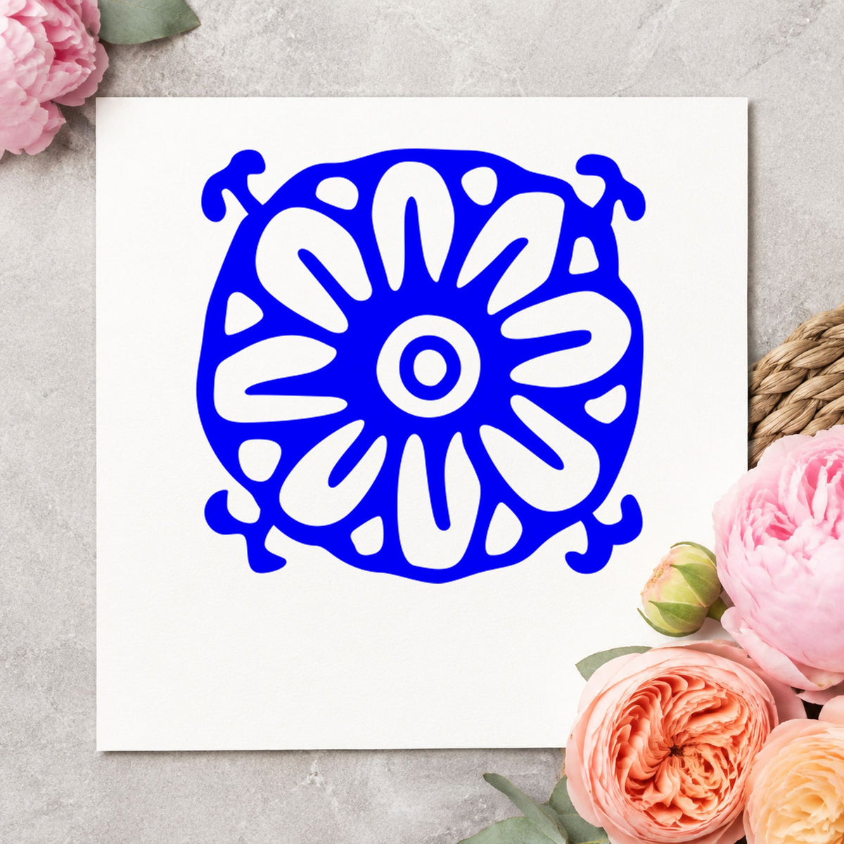 Square Flower Motif Rubber Stamp impression in blue ink on white paper in a styled craft setting.