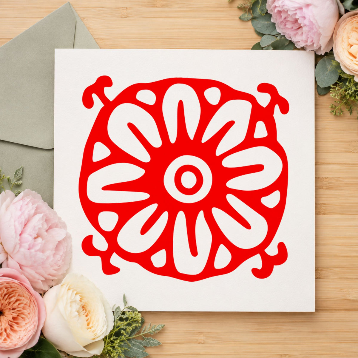 Square Flower Motif Rubber Stamp impression in red ink on white paper in a styled craft setting.