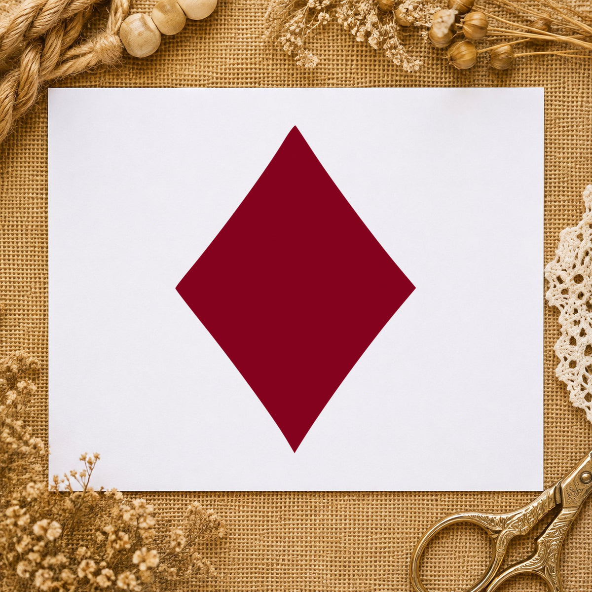 Playing Card Diamond Rubber Stamp impression in burgundy ink on white paper in a styled craft setting.