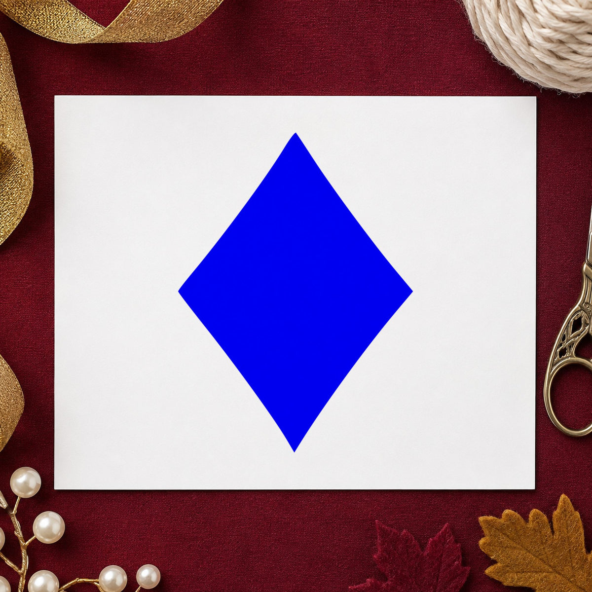 Playing Card Diamond Rubber Stamp impression in blue ink on white paper in a styled craft setting.