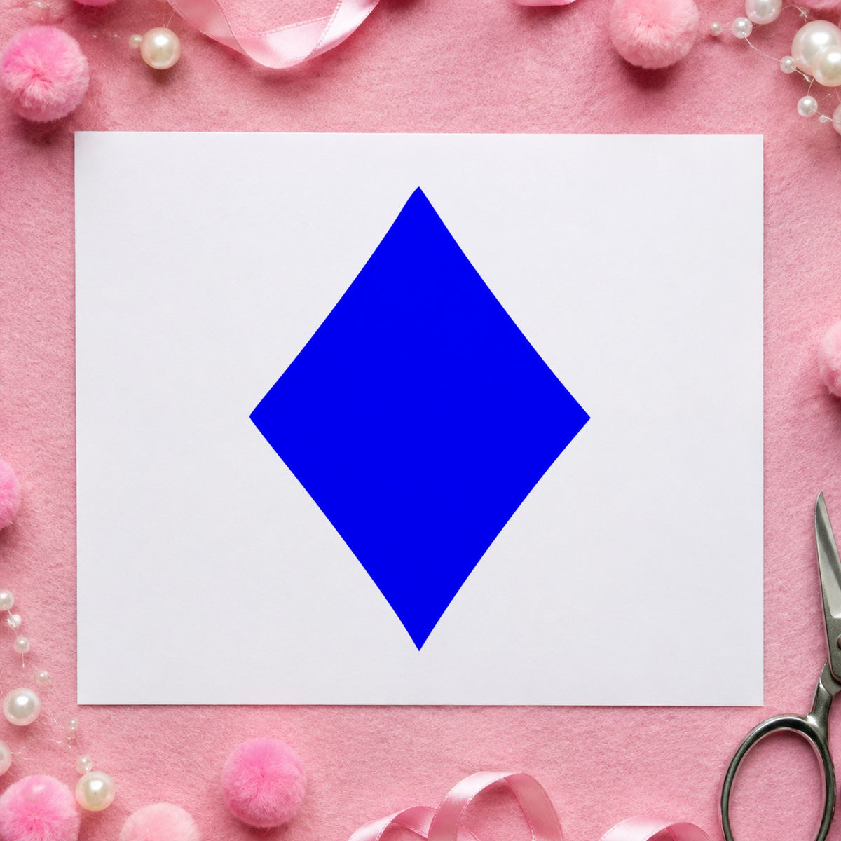 Blue playing card stamp impression featuring the playing card diamond design on white paper.