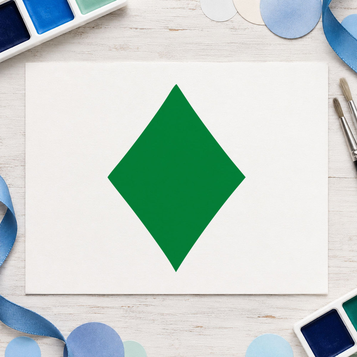 Playing Card Diamond Rubber Stamp impression in green ink on white paper in a styled craft setting.
