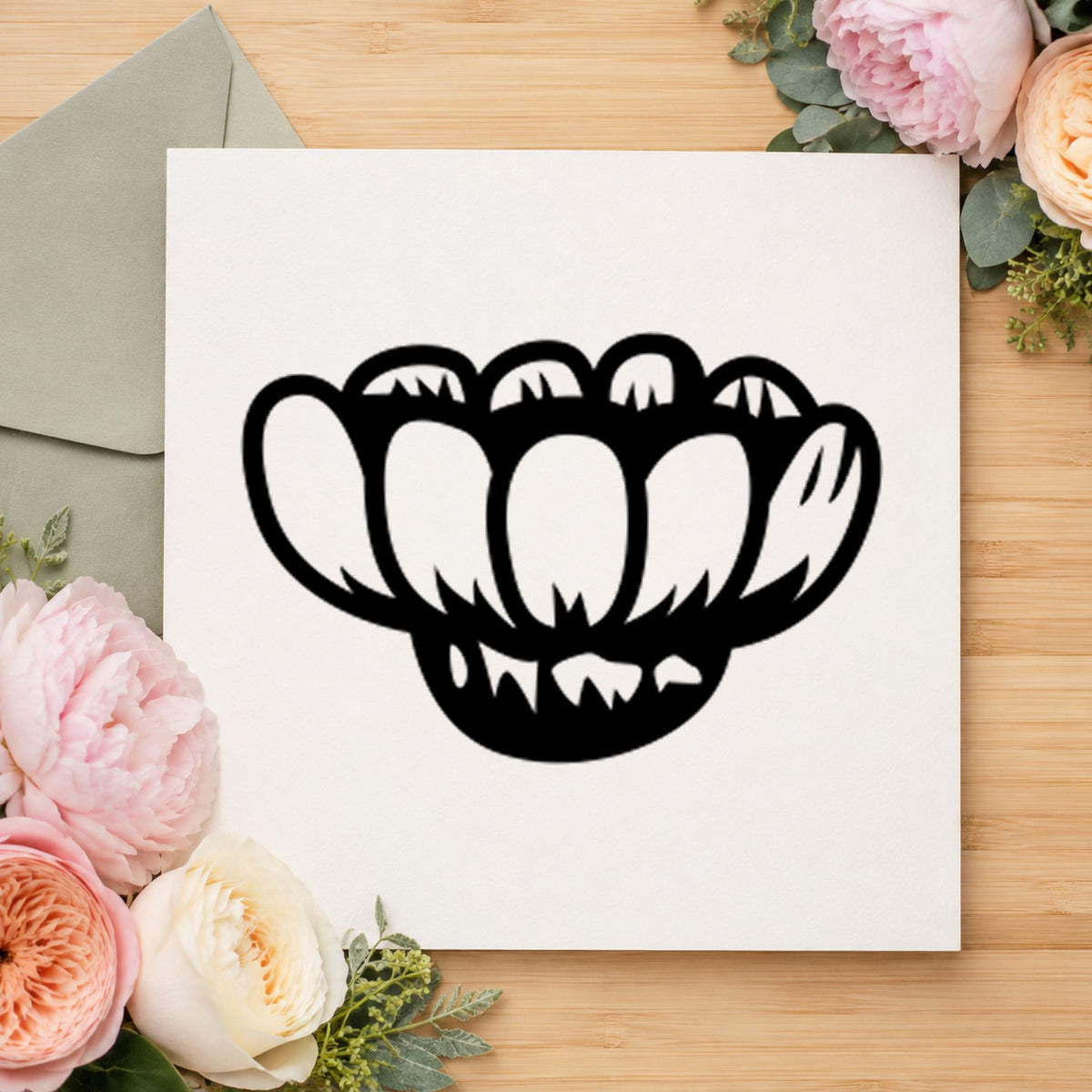 Black impression from a daisy flower stamp, featuring the sideways daisy design on white paper.
