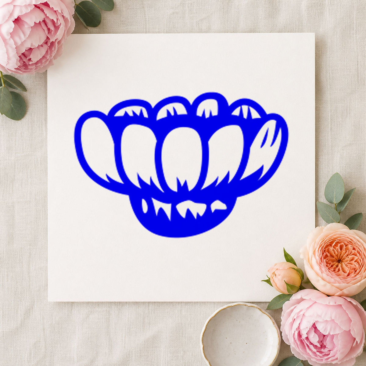 Blue floral card making stamp impression featuring the sideways daisy design on white paper.