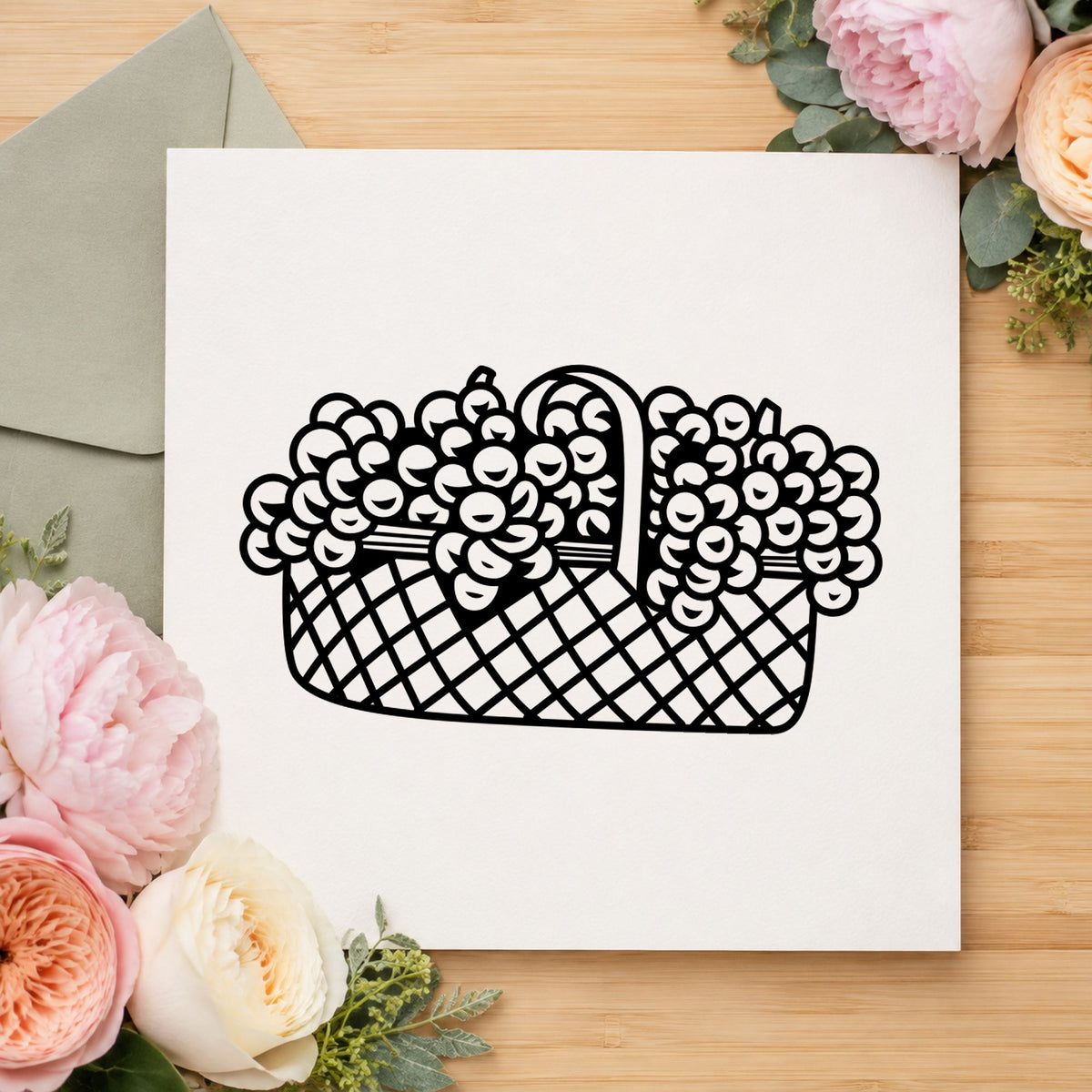 Black impression from a flower basket stamp, featuring the basket of flowers large design on white paper.