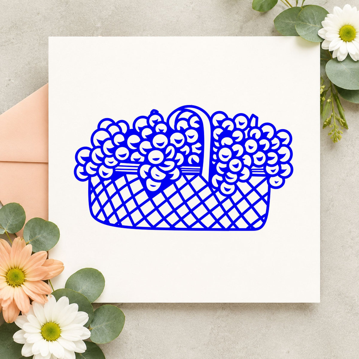 Blue spring craft stamp impression featuring the basket of flowers small design on white paper.