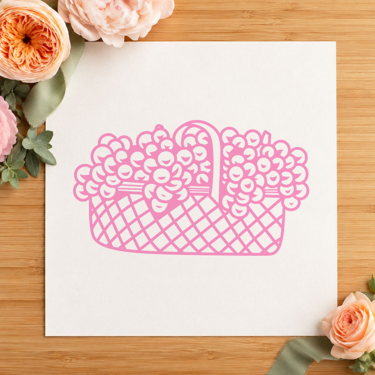 Basket of Flowers Rubber Stamp Small impression in pink ink on white paper in a styled craft setting.