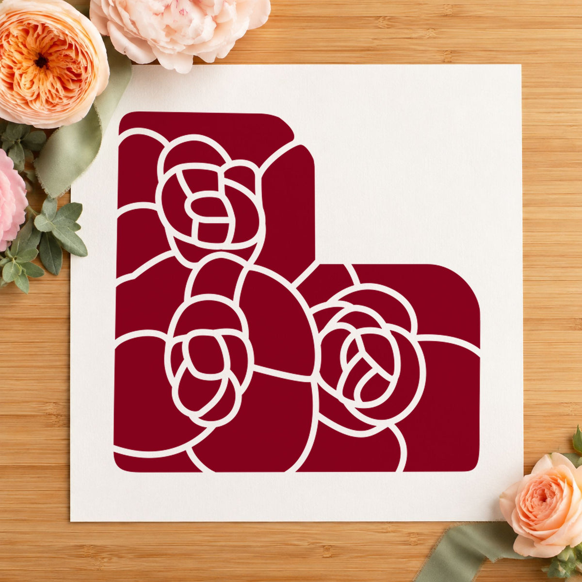 Three Solid Flowers Corner Rubber Stamp impression in burgundy ink on white paper in a styled craft setting.