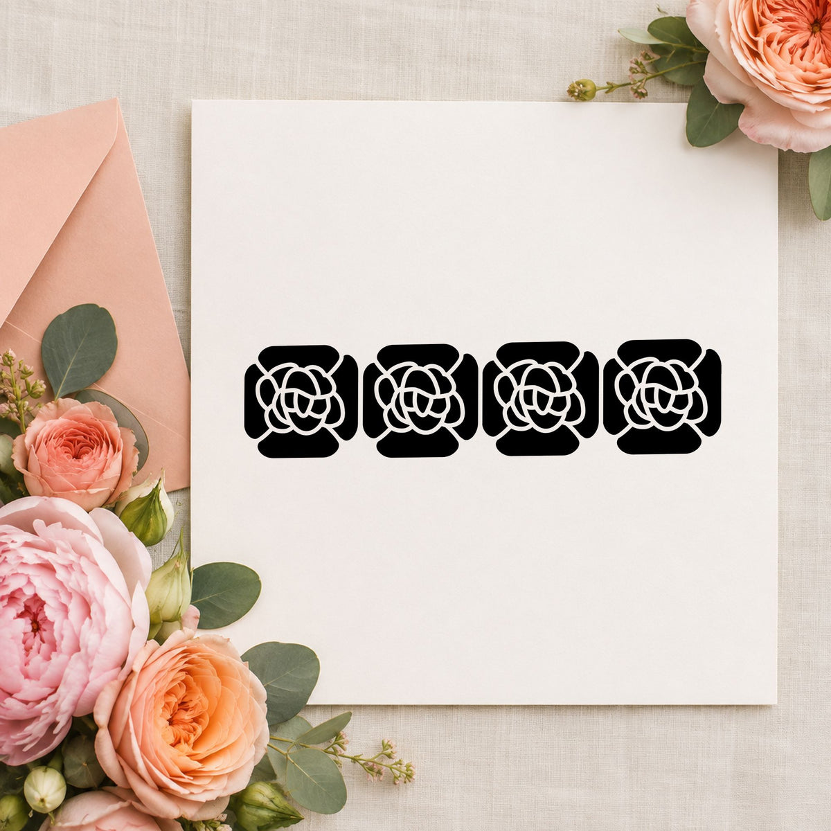 Black impression from a floral border rubber stamp, featuring the four solid flowers border design on white paper.