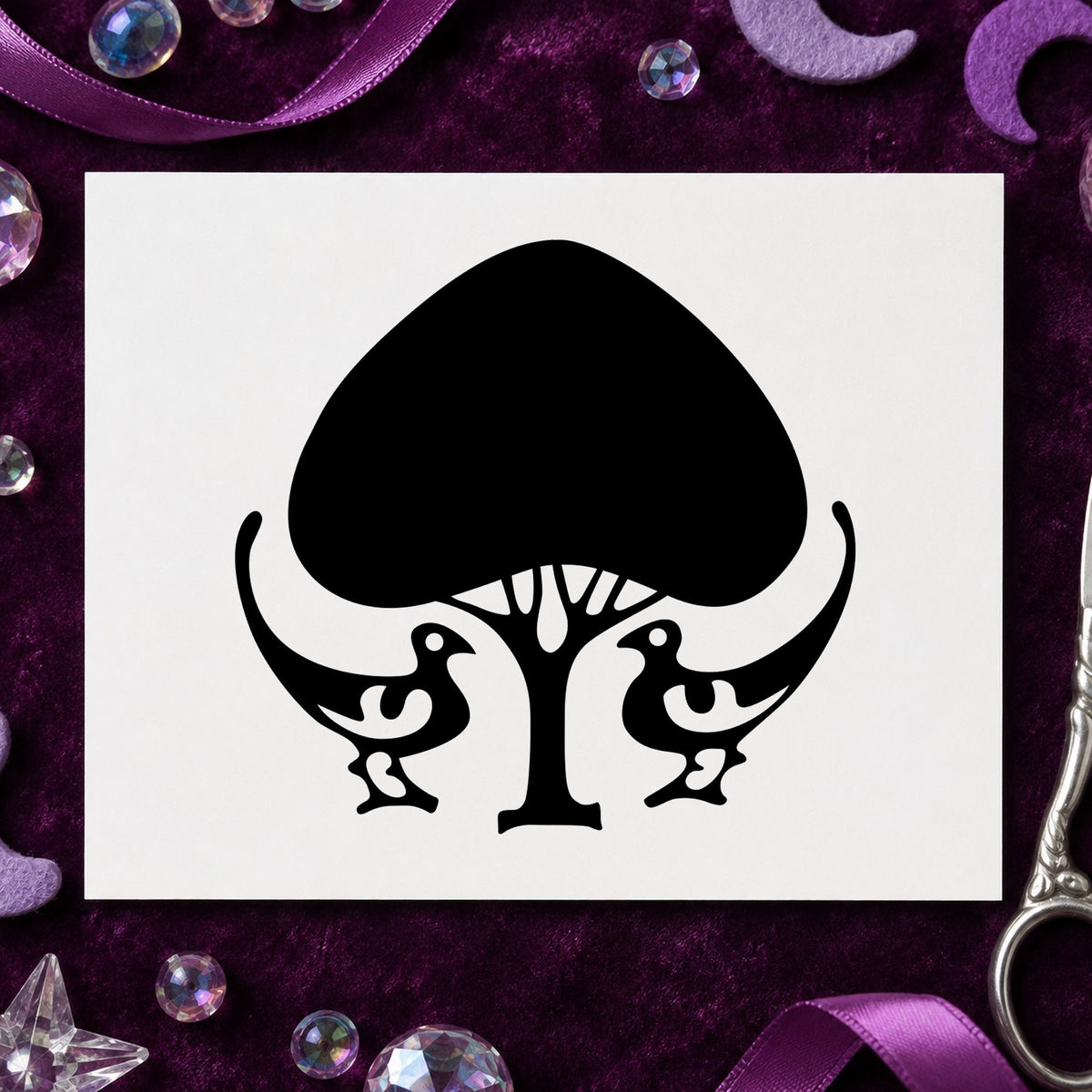 Black impression from a tree rubber stamp, featuring the leafy tree and birds design on white paper.