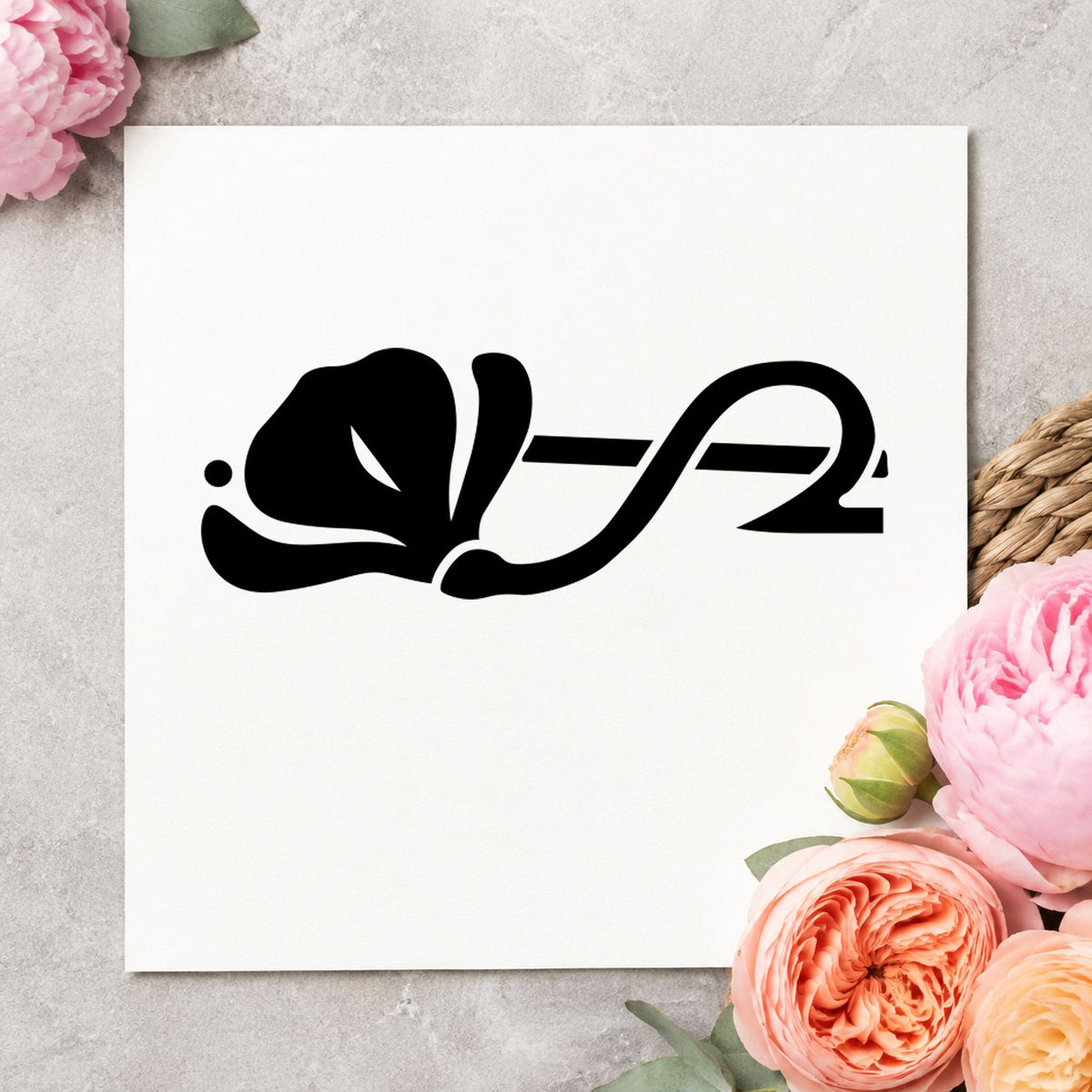 Black impression from a floral border stamp, featuring the left flower border design on white paper.