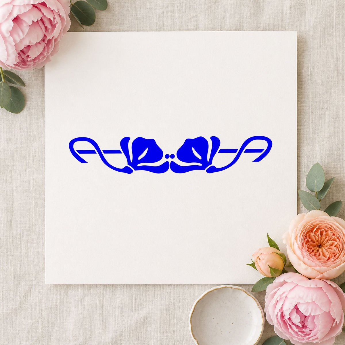 Double Flower Border Rubber Stamp impression in blue ink on white paper in a styled craft setting.
