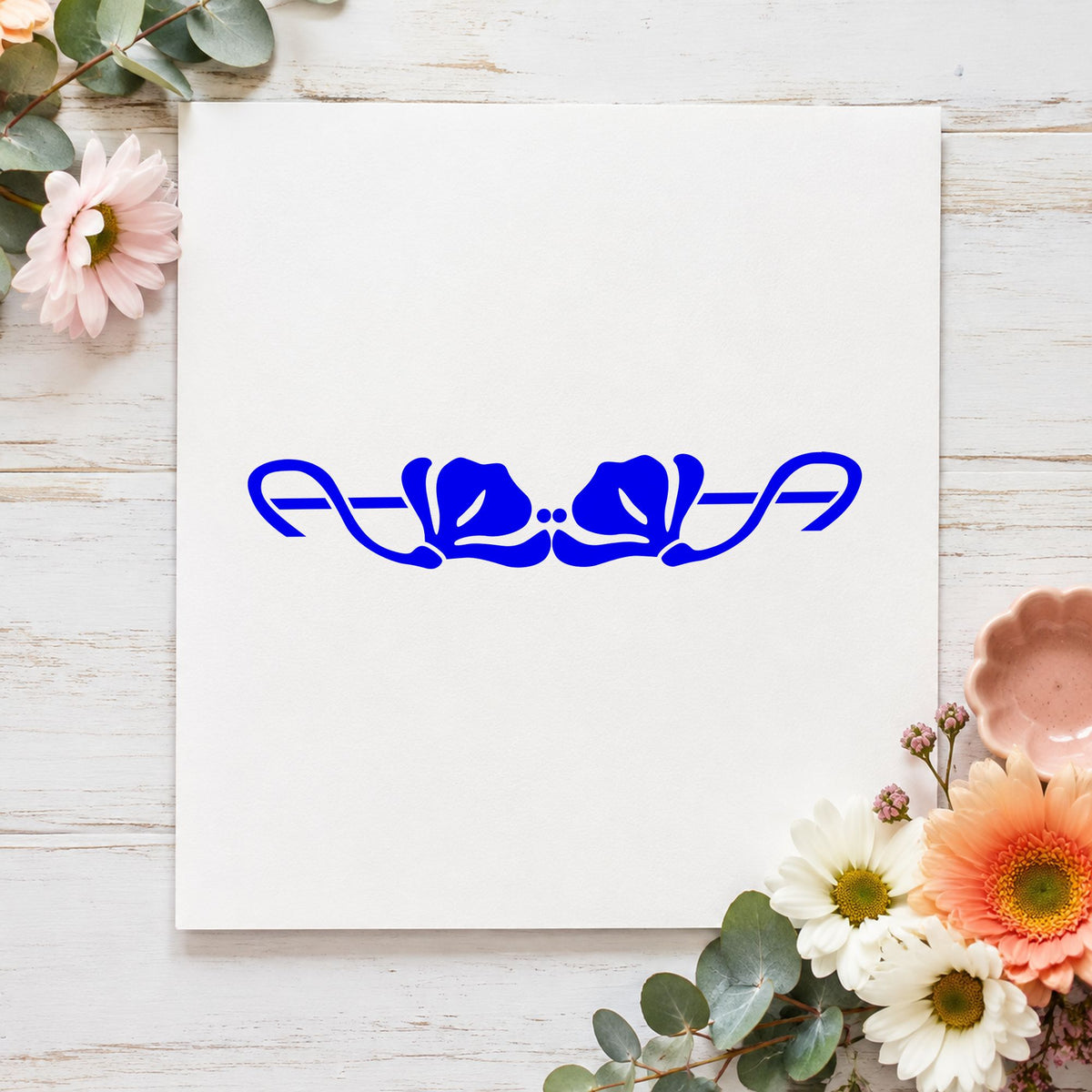 Blue spring card making stamp impression featuring the double flower border design on white paper.