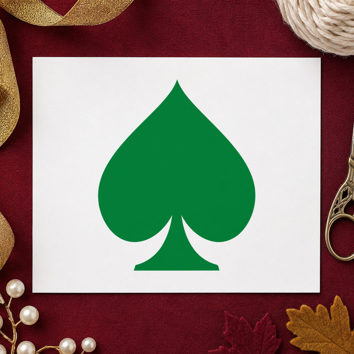 Playing Card Spade Rubber Stamp impression in green ink on white paper in a styled craft setting.