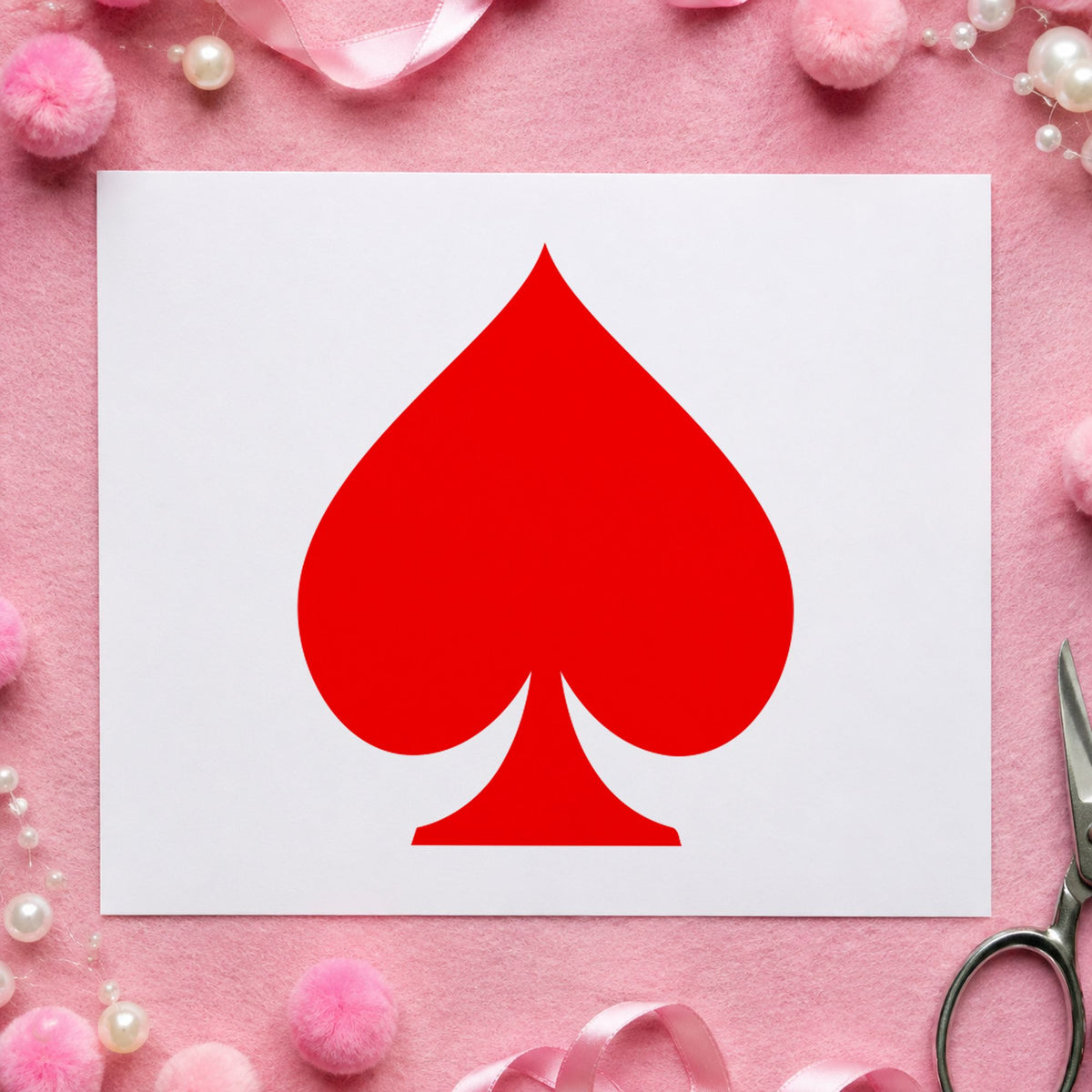 Playing Card Spade Rubber Stamp impression in red ink on white paper in a styled craft setting.