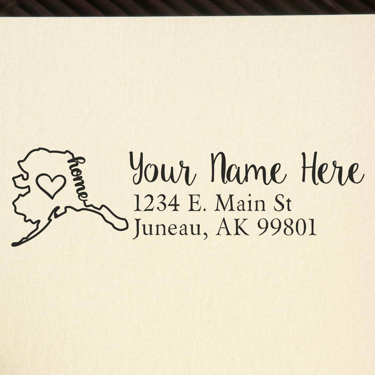 Personalized Alaska return address rubber stamp with home icon, name placeholder, and Juneau, AK mailing address.