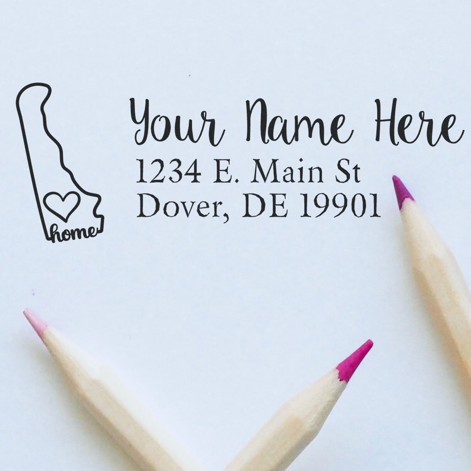 Custom address rubber stamp proof with personalized name, return address, and Delaware home design for mailing.