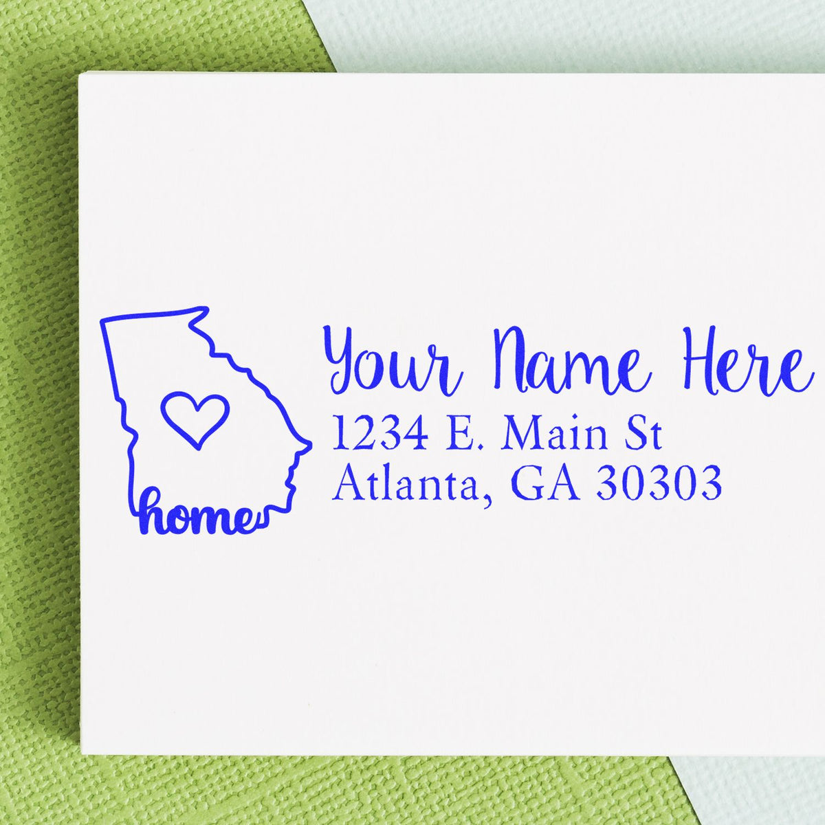 Custom rubber stamp impression with Georgia home design, heart, and personalized return address for envelopes.