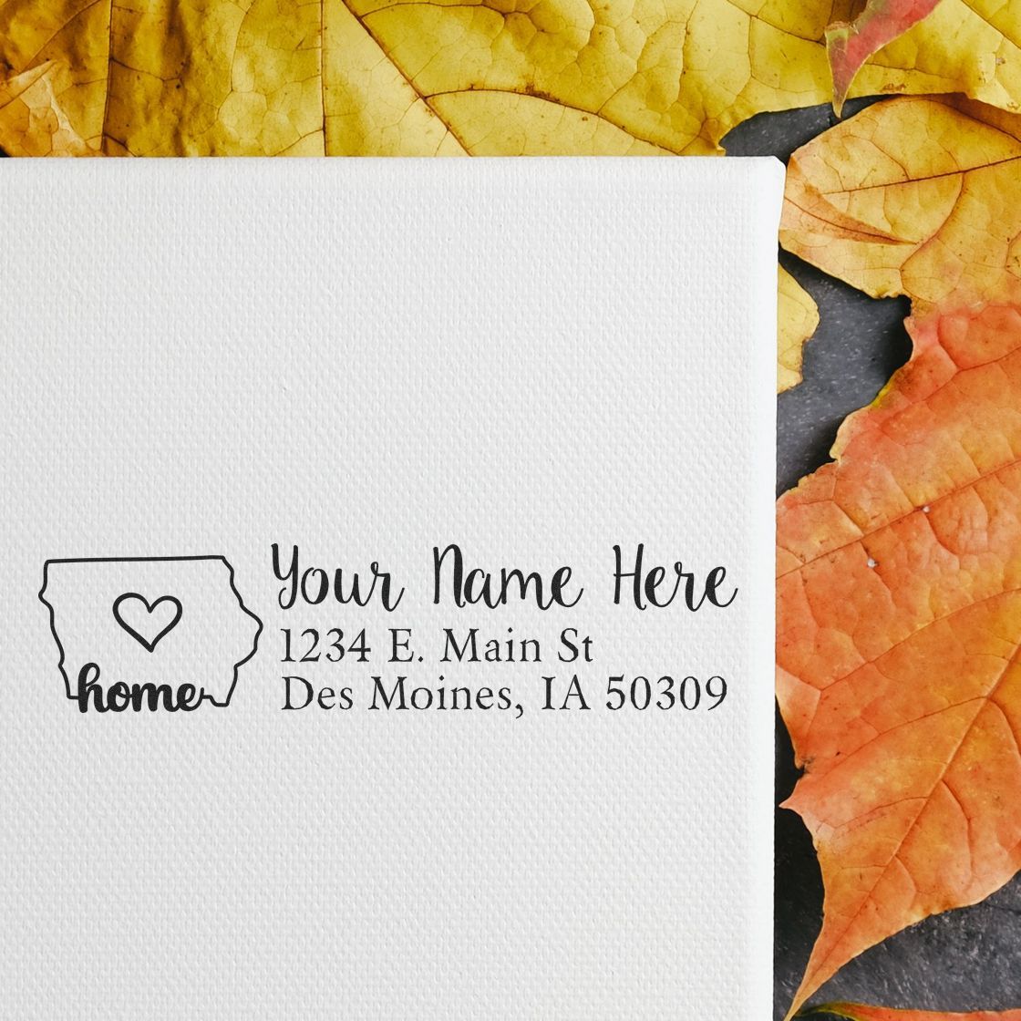 Custom rubber address stamp with Iowa home icon, personalized name, and return address on white card.