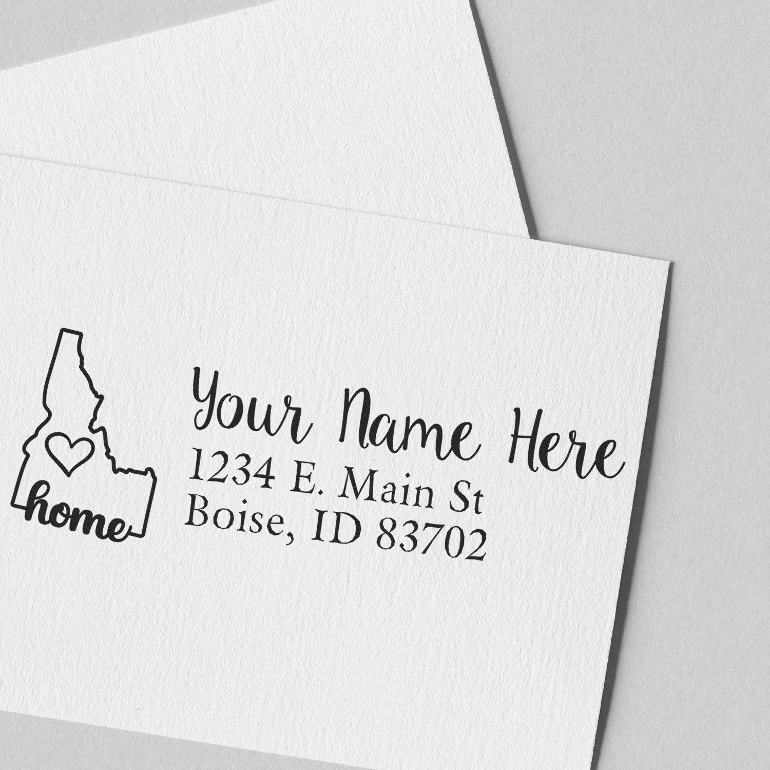 Personalized return address rubber stamp with Idaho home logo, name, and Boise address on white envelope.