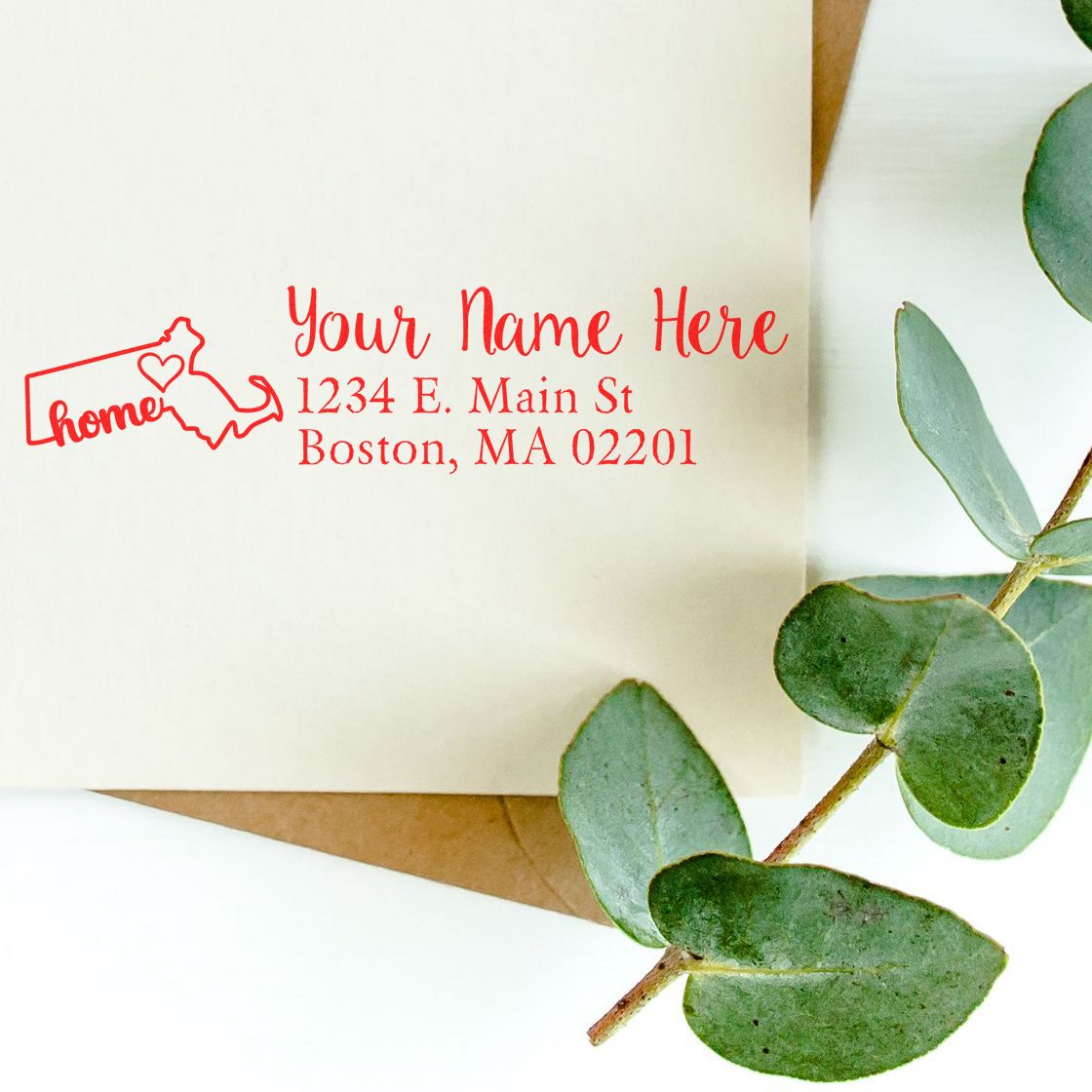 Custom return address rubber stamp impression with Massachusetts home icon, name, and Boston address on an envelope.