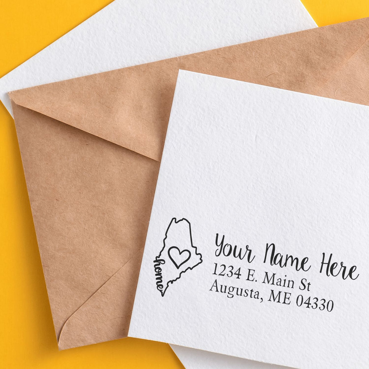 Custom address rubber stamp with Maine outline heart design, perfect for personalized return addresses on envelopes.