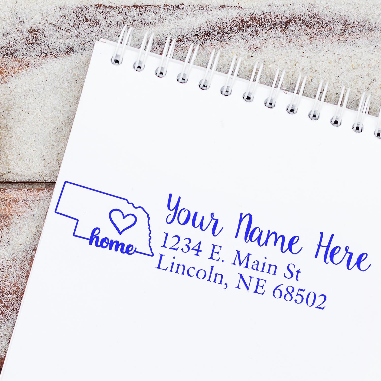 Custom rubber address stamp with Nebraska outline, name, and Lincoln, NE return address for personal stationery.