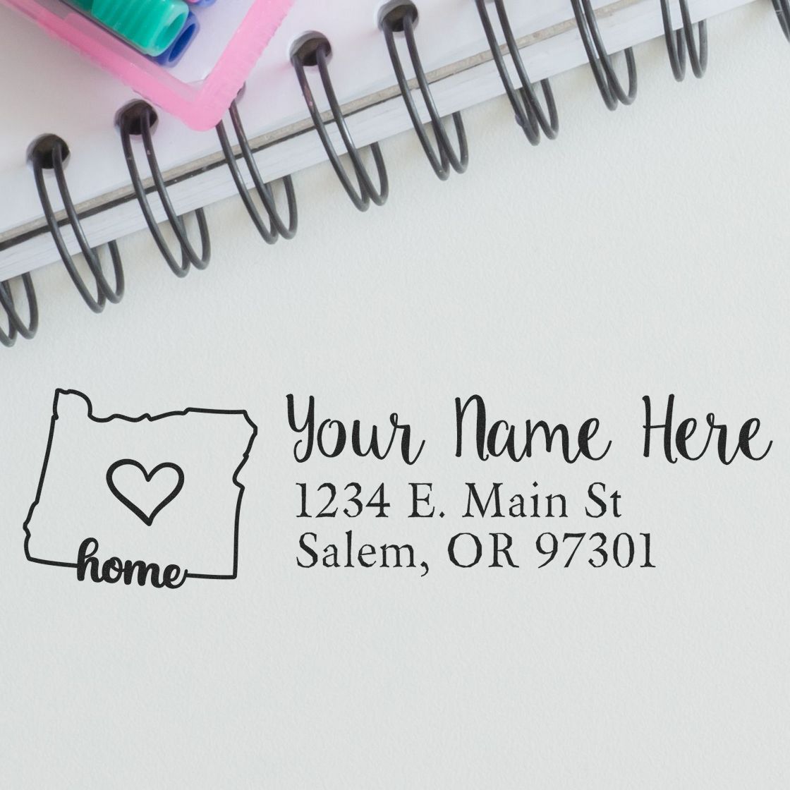 Custom rubber stamp with Oregon home icon and personalized return address: Your Name Here, 1234 E. Main St, Salem, OR.
